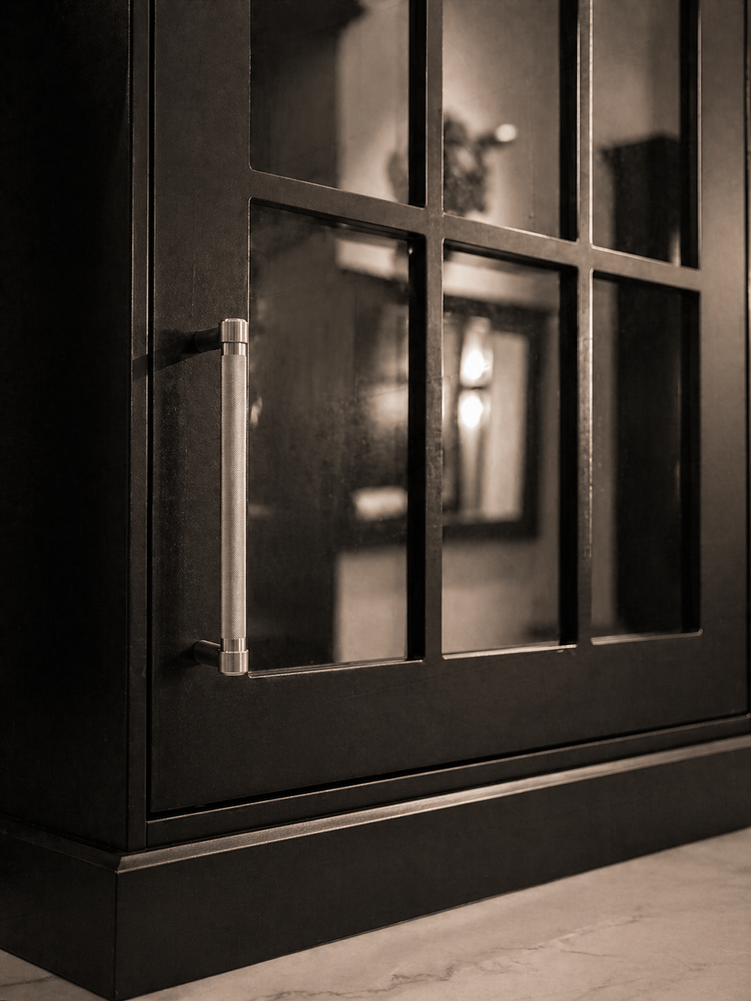 Tight crop of a mullioned glass cabinet door