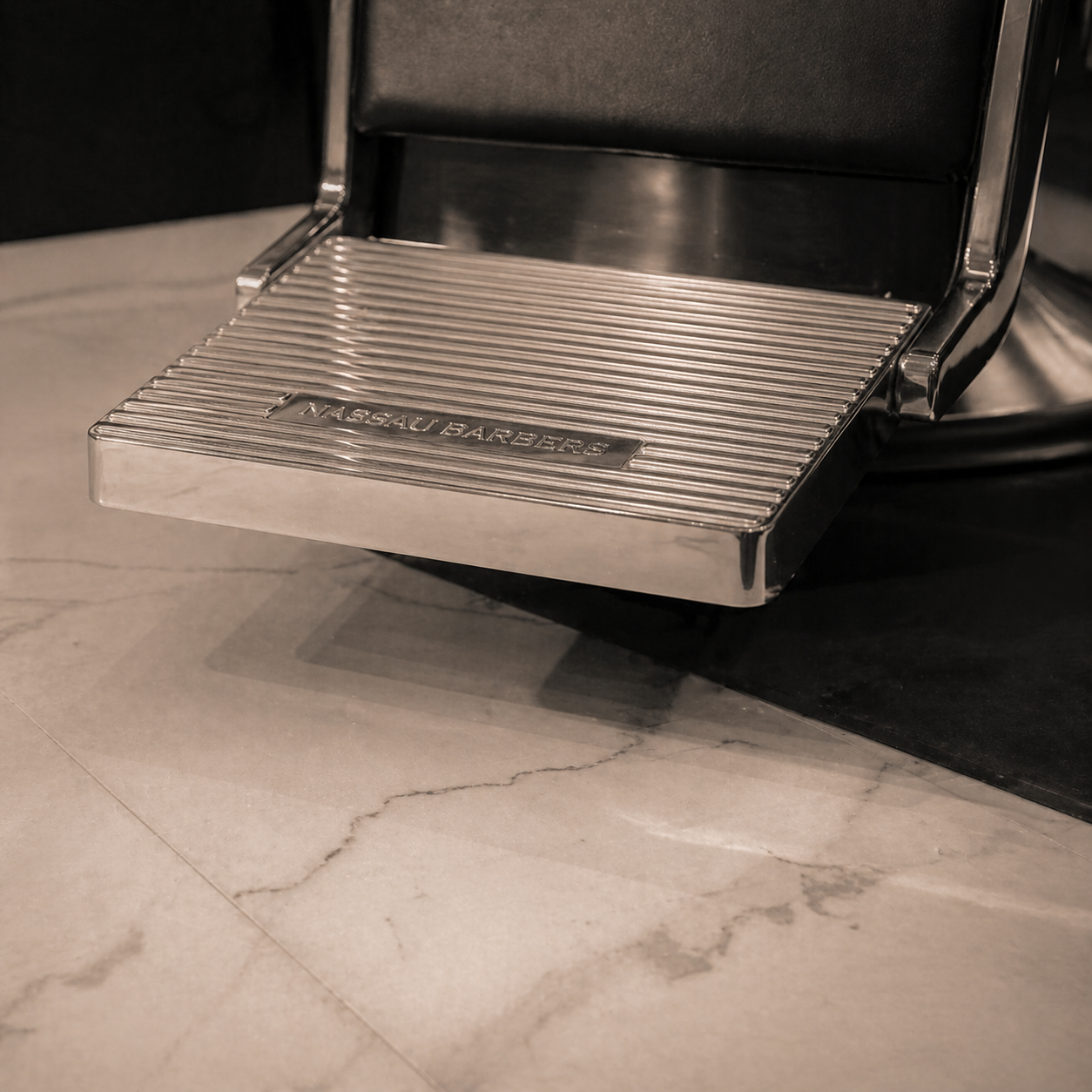 Chrome step plate of a barber chair, low angle